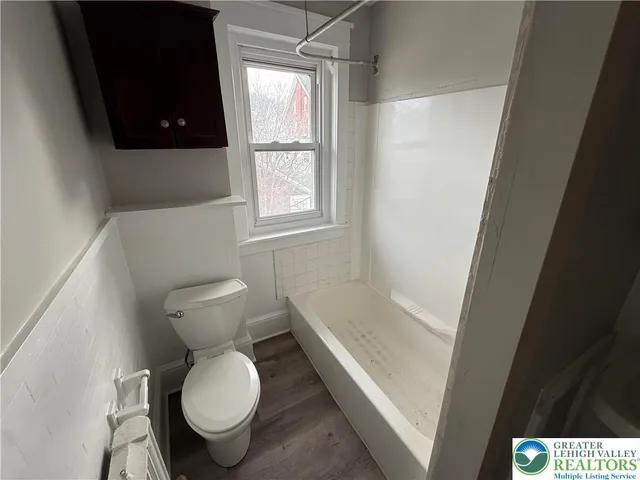 a bathroom with a toilet and a shower