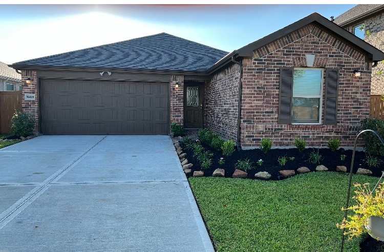 a front view of a house with a garden