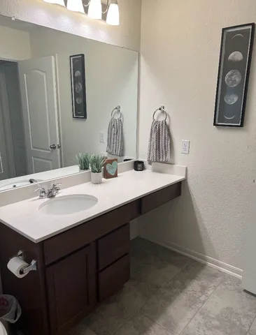 a bathroom with a sink vanity and mirror