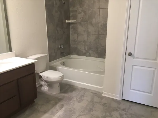 a bathroom with a toilet and a bathtub