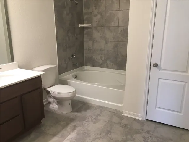 a bathroom with a toilet and a bathtub