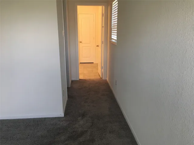 a view of a hallway with a wooden floor