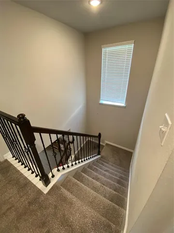 an empty room with a mirror and a ceiling fan