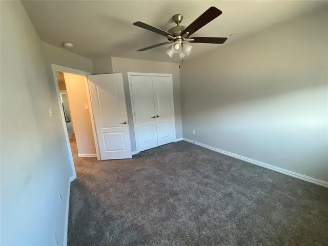a view of a livingroom with a ceiling fan and window