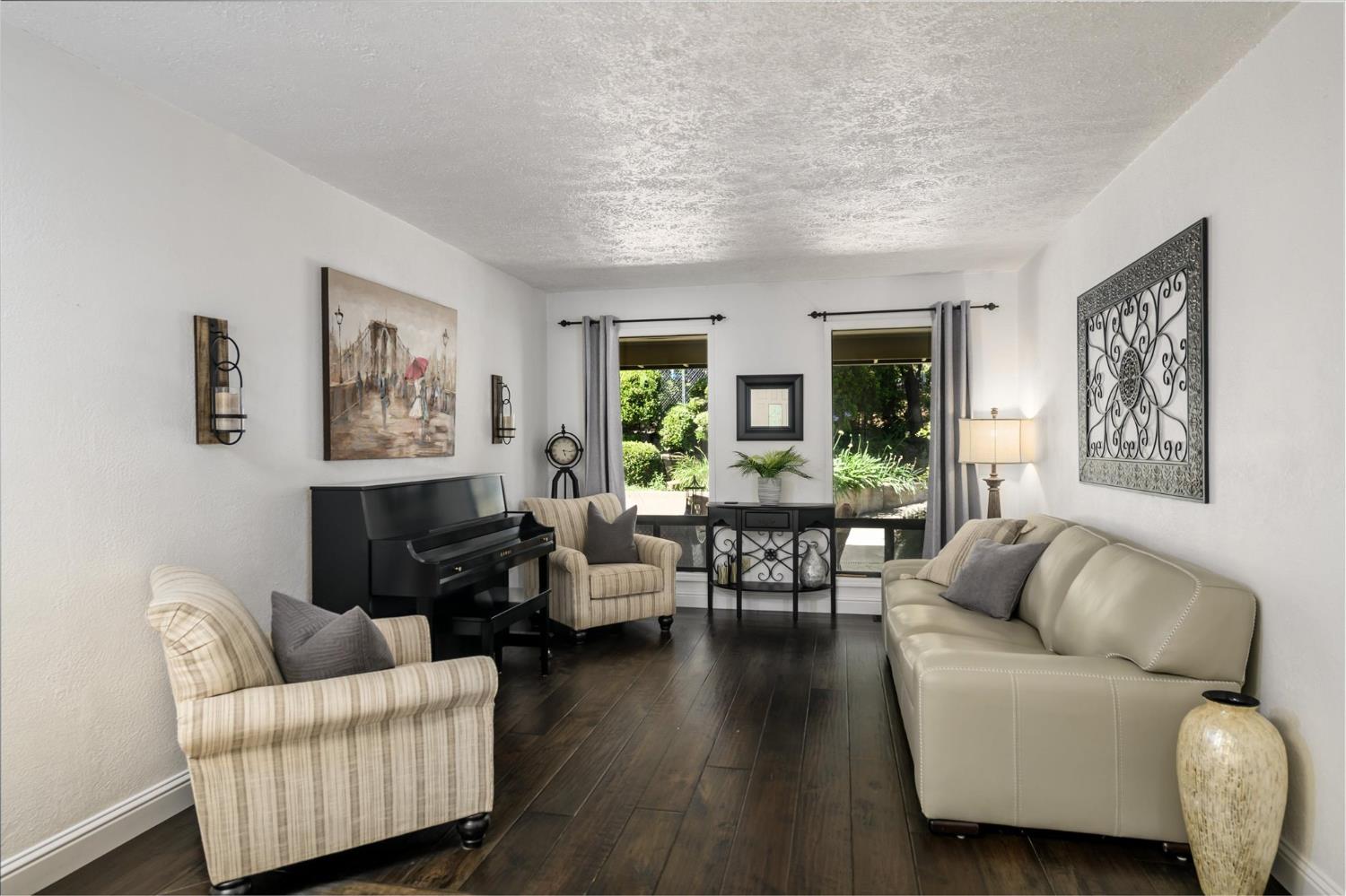 3165 Oakwood Road Cameron Park, CA 95682 - Photo 6 of 55 The family room showcases beautiful backyard views through floor-to-ceiling windows and is complemented by rich hickory scraped flooring.