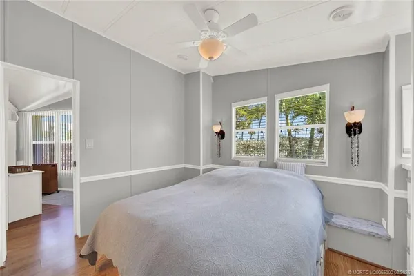 a spacious bedroom with a large bed and a large window