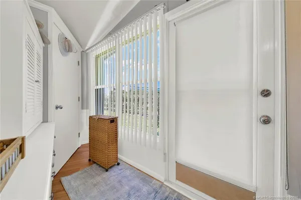 a view of entryway with wooden floor and door