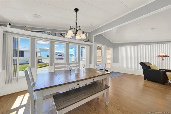 a view of a dining room with furniture wooden floor and chandelier