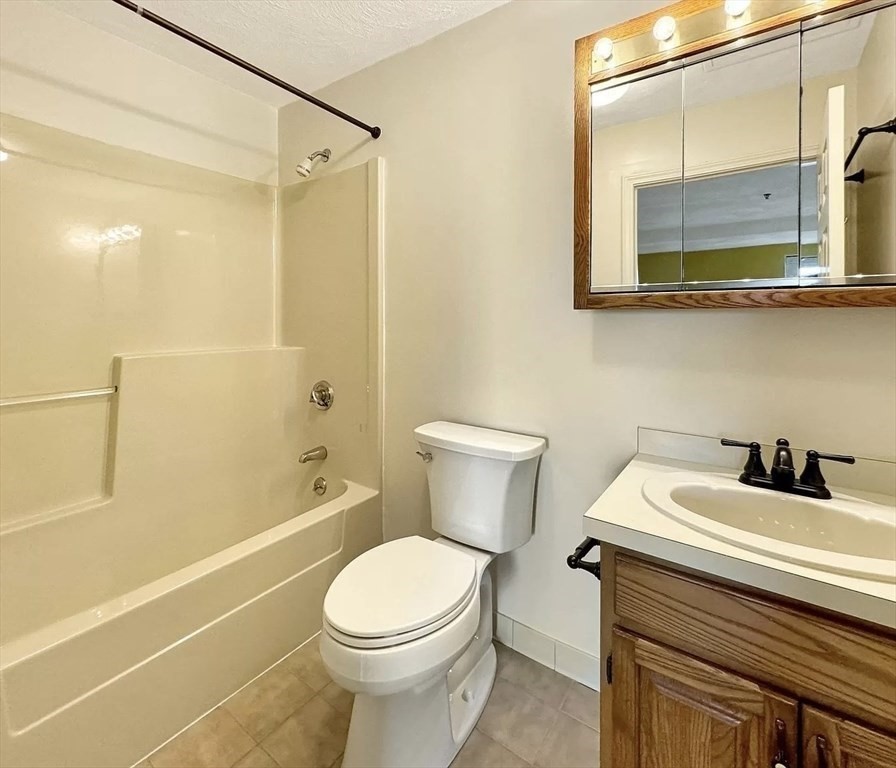 39 Parlin Street, Unit 404 Everett, MA 02149 - Photo 14 of 25 a bathroom with a sink a toilet and shower
