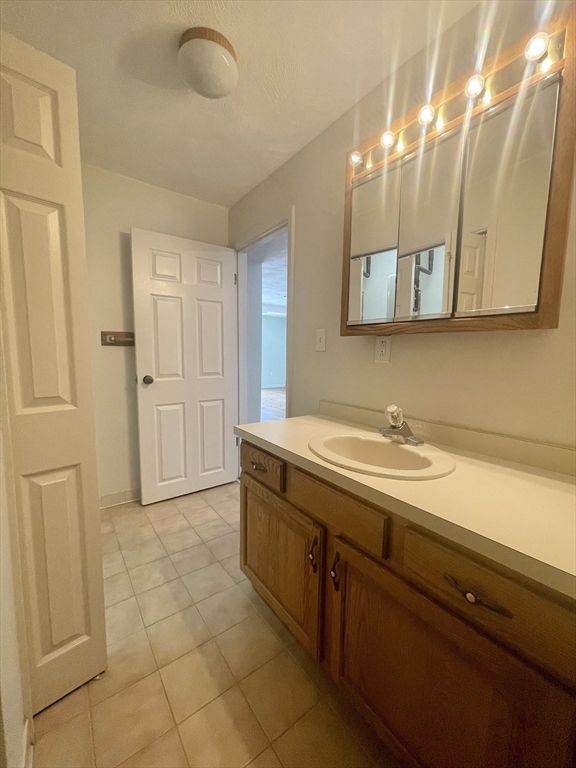 39 Parlin Street, Unit 404 Everett, MA 02149 - Photo 18 of 25 a bathroom with a sink and a mirror