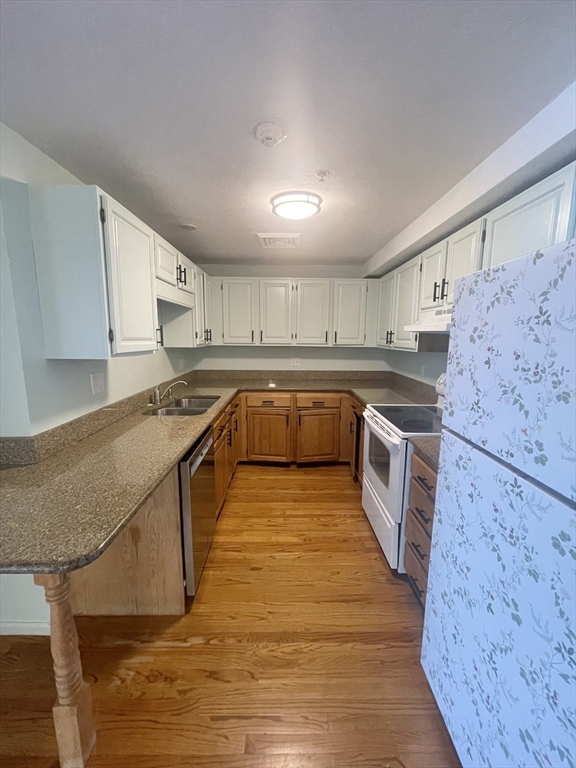 39 Parlin Street, Unit 404 Everett, MA 02149 - Photo 2 of 25 a kitchen with stainless steel appliances granite countertop a stove a sink dishwasher and a refrigerator
