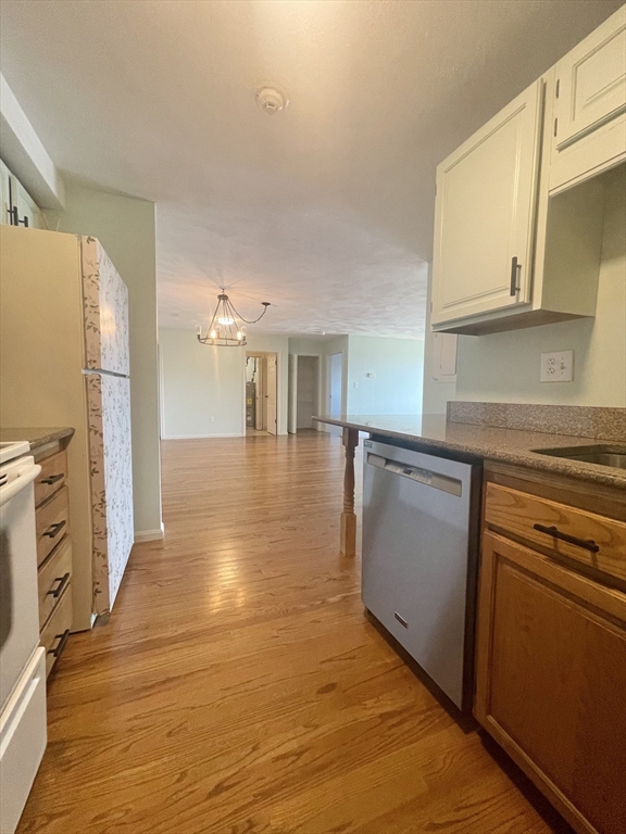 39 Parlin Street, Unit 404 Everett, MA 02149 - Photo 3 of 25 a view of a kitchen with a sink and cabinets