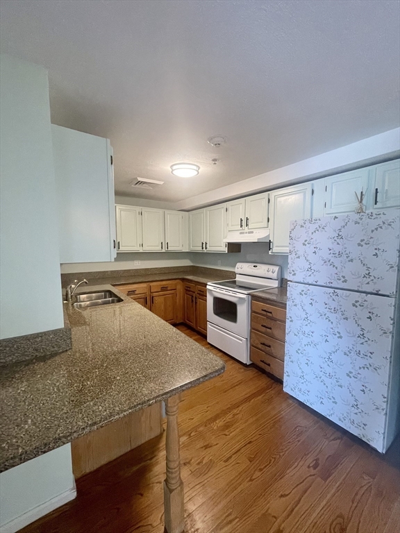 39 Parlin Street, Unit 404 Everett, MA 02149 - Photo 4 of 25 a kitchen with stainless steel appliances granite countertop a sink counter space and cabinets