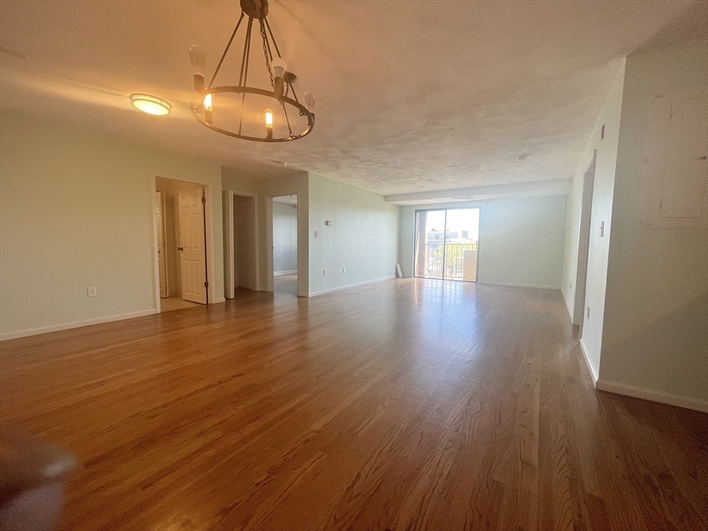 39 Parlin Street, Unit 404 Everett, MA 02149 - Photo 6 of 25 a view of an empty room with wooden floor