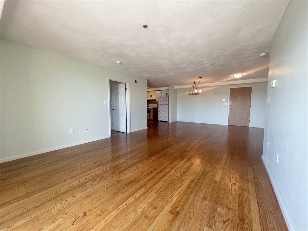 39 Parlin Street, Unit 404 Everett, MA 02149 - Photo 7 of 25 wooden floor in an empty room with a window