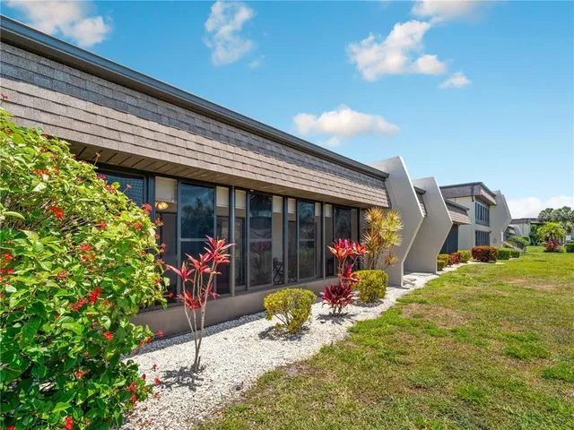 a front view of a house with swimming pool and porch