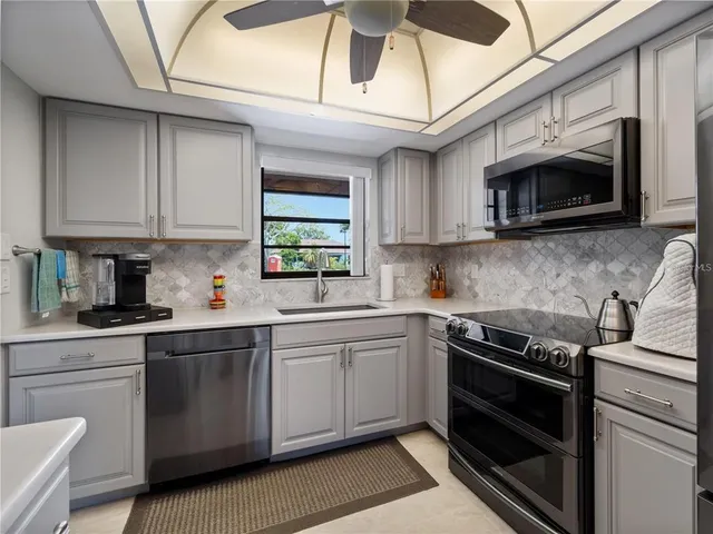 a kitchen with stainless steel appliances granite countertop a stove and a sink