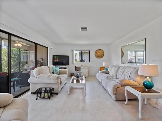 a living room with furniture and large windows