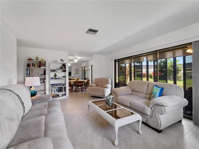a view of a dining room with furniture and a chandelier