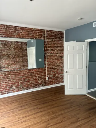 an empty room with wooden floor