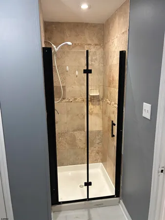 a bathroom with a glass shower door