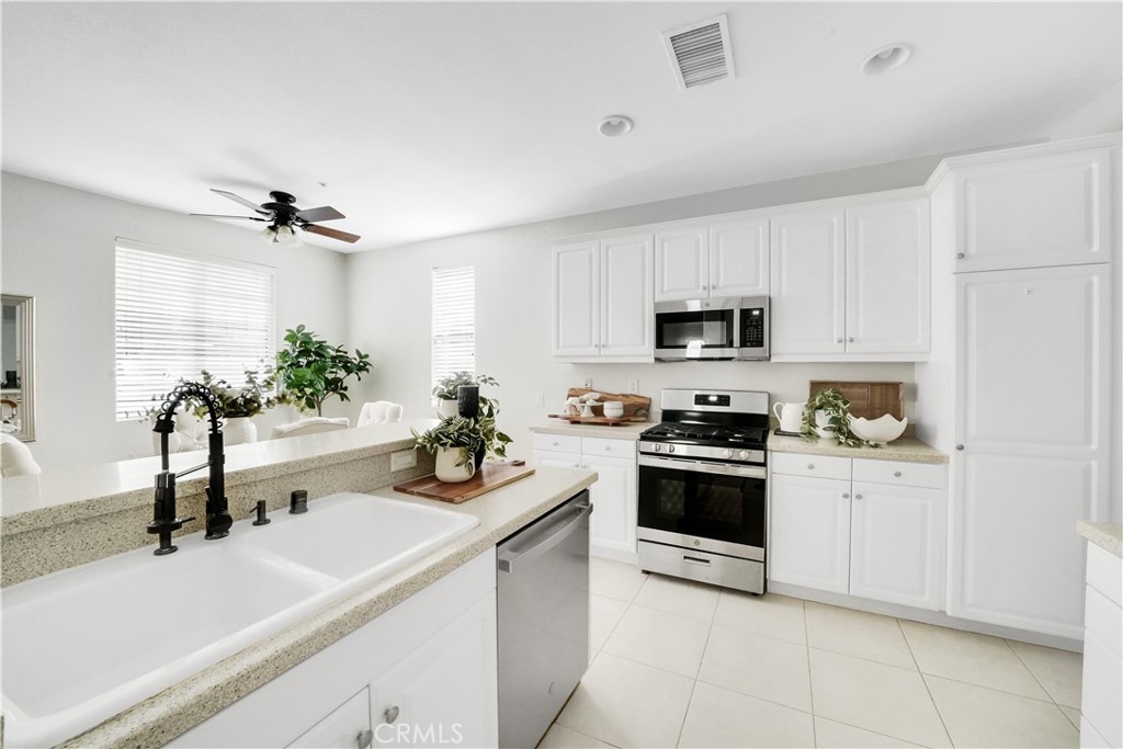 6 Chadron Circle Ladera Ranch, CA 92694 - Photo 14 of 45 a kitchen with white cabinets and stainless steel appliances