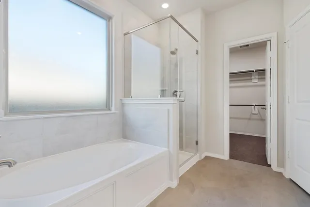 a bathroom with a tub and a shower