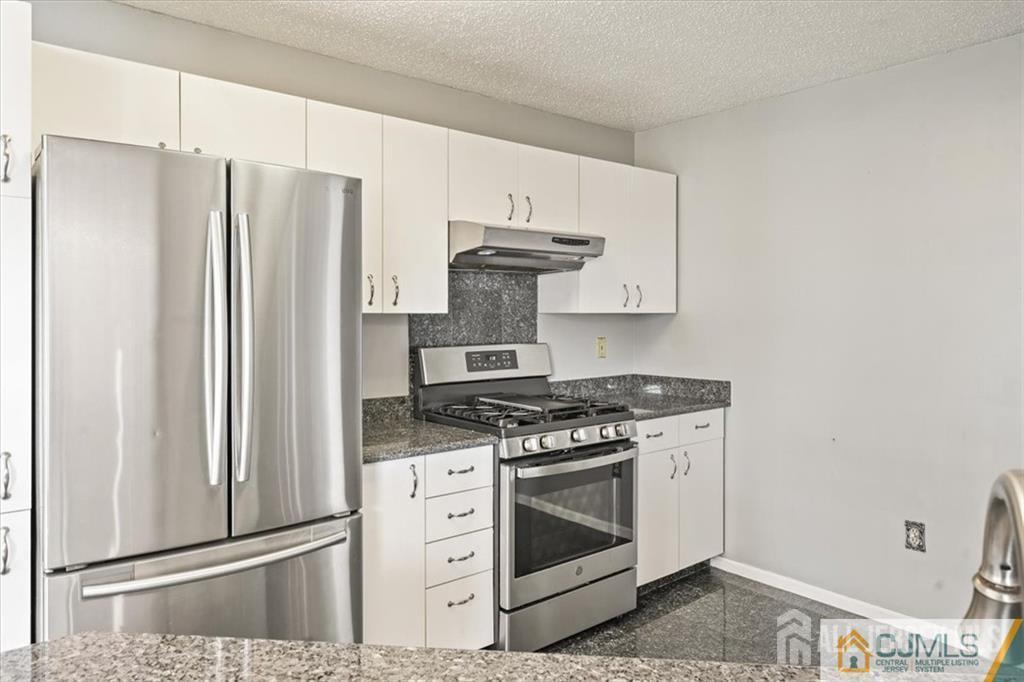 834 Edpas Road New Brunswick, NJ 08901 - Photo 10 of 20 a kitchen with stainless steel appliances a stove and a refrigerator