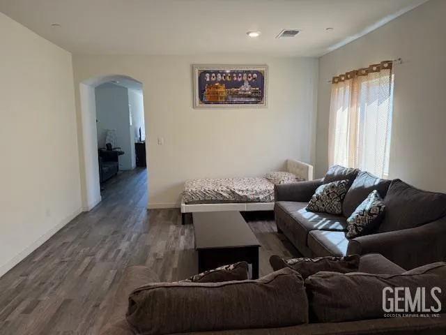 a living room with furniture and a wooden floor