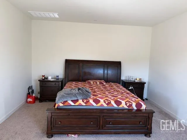a bedroom with a bed and dresser