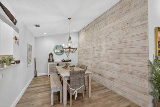 a view of a dining room with furniture wooden floor and chandelier