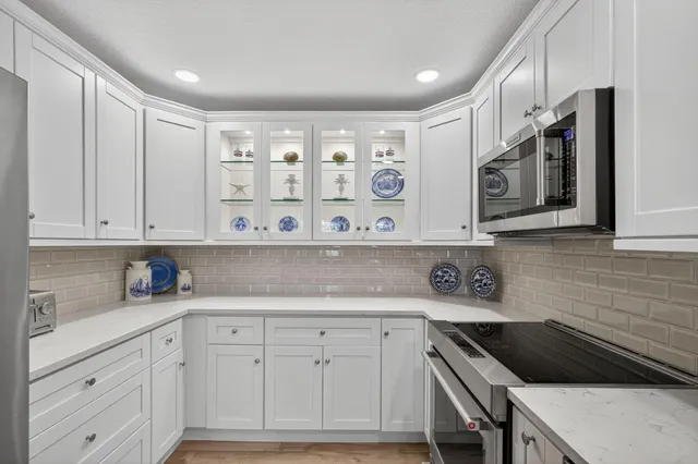 a spacious bedroom with a bed and a chandelier