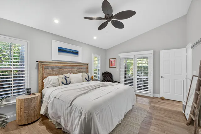 a bedroom with a bed and a ceiling fan