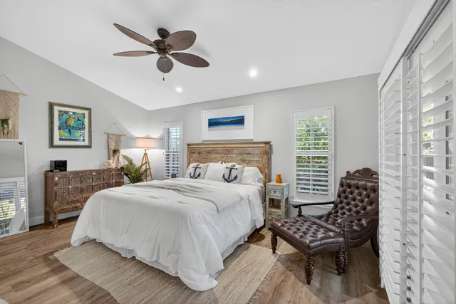 a bathroom with a granite countertop sink a toilet and a shower