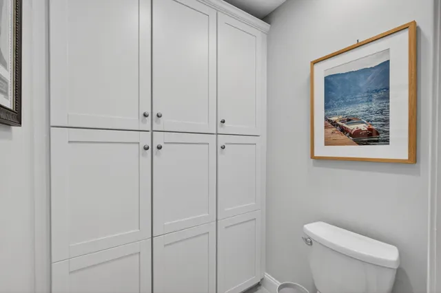 a dining room with furniture a chandelier and wooden floor