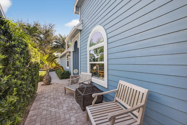 an aerial view of a houses with a swimming pool outdoor seating and city view