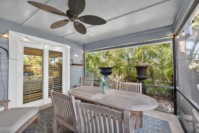 a view of a tennis ground with large trees