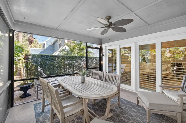 a view of a patio with table and chairs and potted plants