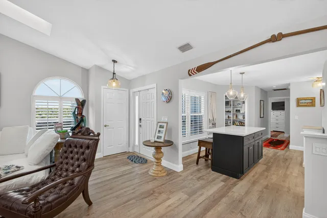 a living room with furniture a window and a flat screen tv