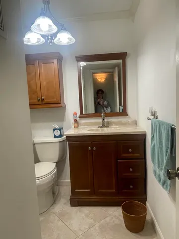 a white toilet sitting next to a shower