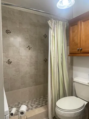 a bathroom with a shower and mirror