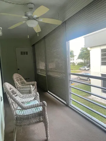 a white toilet sitting next to a shower