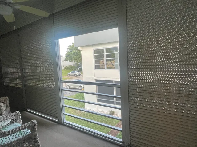 a kitchen with stainless steel appliances a refrigerator a sink and wooden floors