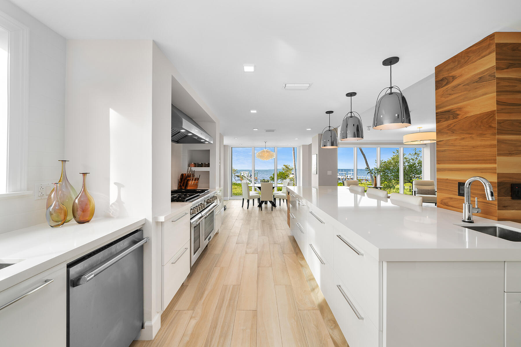 108 North Bounty Lane Key Largo, FL 33037 - Photo 51 of 79 a view of a kitchen with kitchen island a large counter top space a sink stainless steel appliances and cabinets