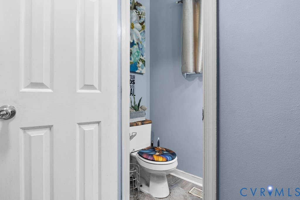 4025 Frye Terrace Colonial Heights, VA 23834 - Photo 7 of 14 Powder room featuring a white toilet, light blue w
