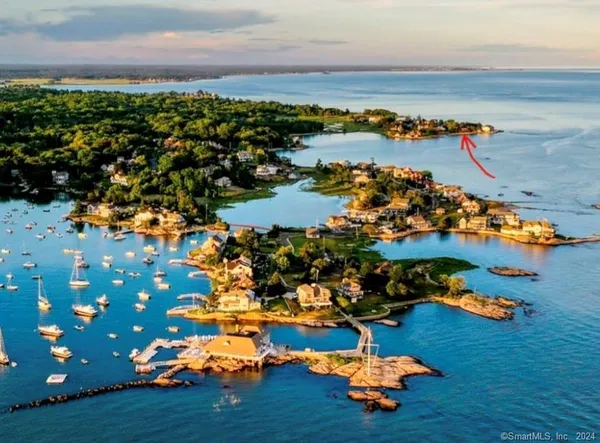 an aerial view of a houses with a lake view