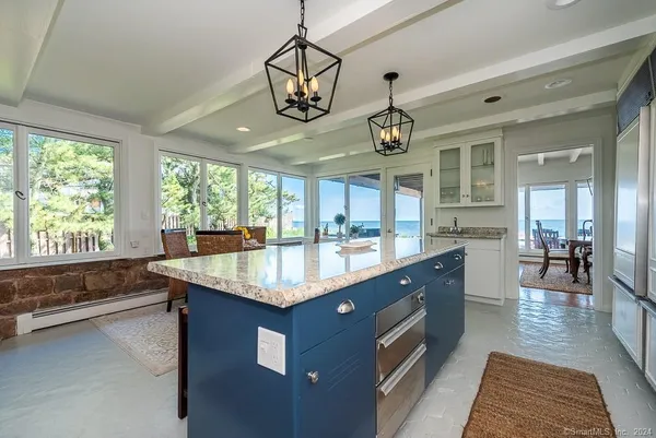 a living room with furniture a wooden floor and a chandelier