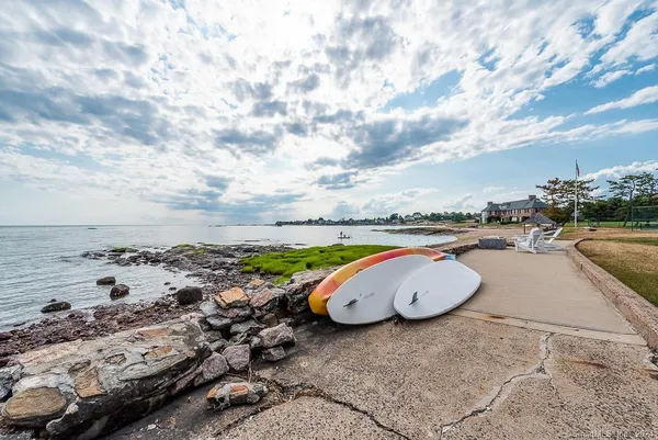 a view of a tennis ground with a large trees