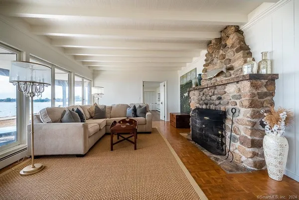 a living room with furniture and large windows