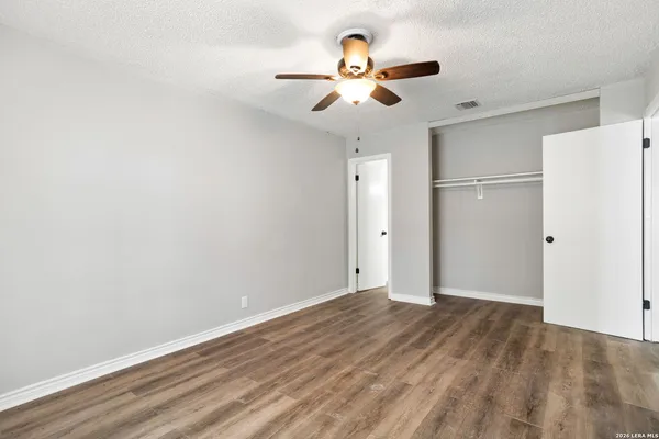 a view of an empty room with a ceiling fan